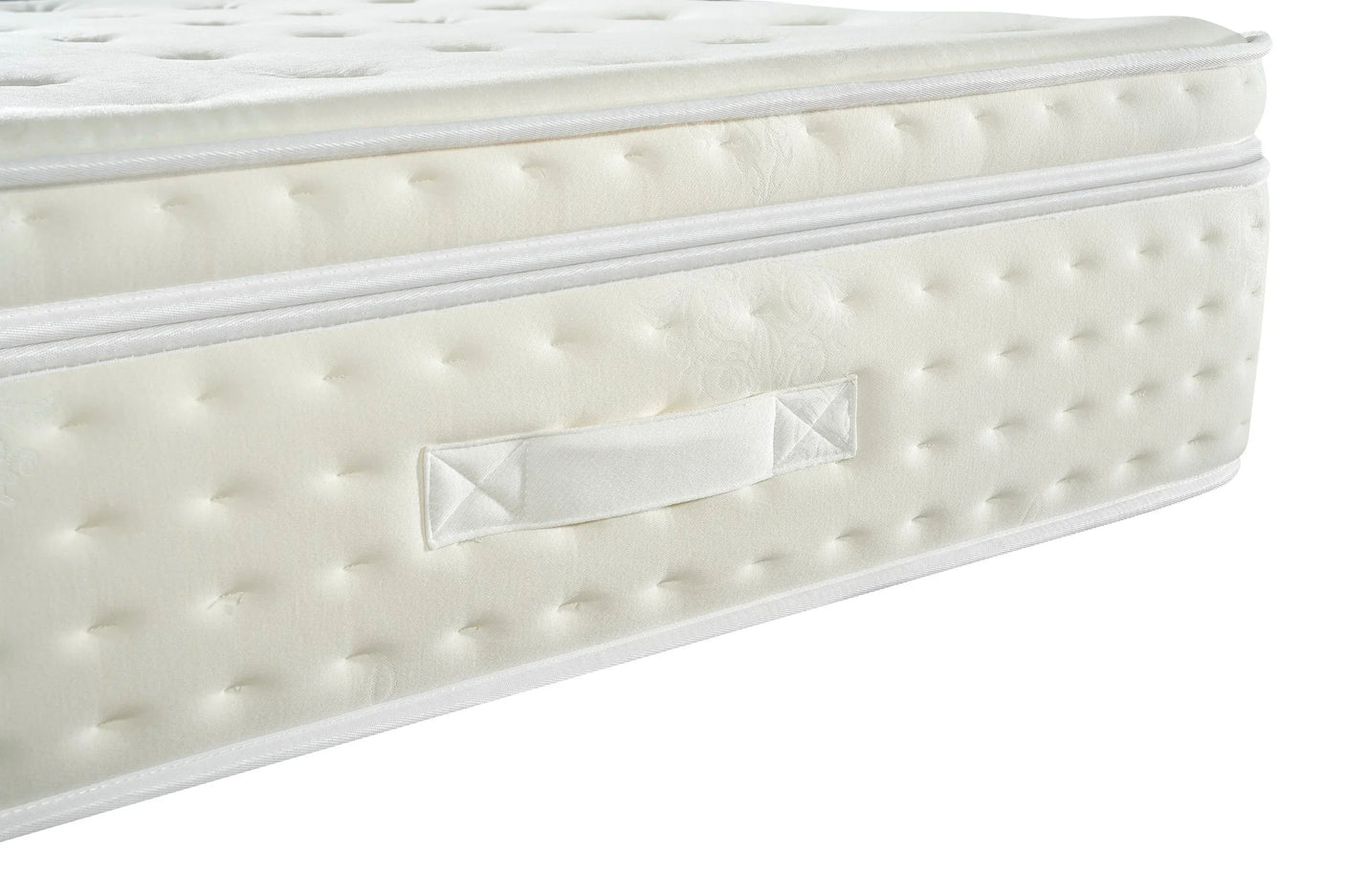 Closeup of white mattress with quilted surface and side fabric handle