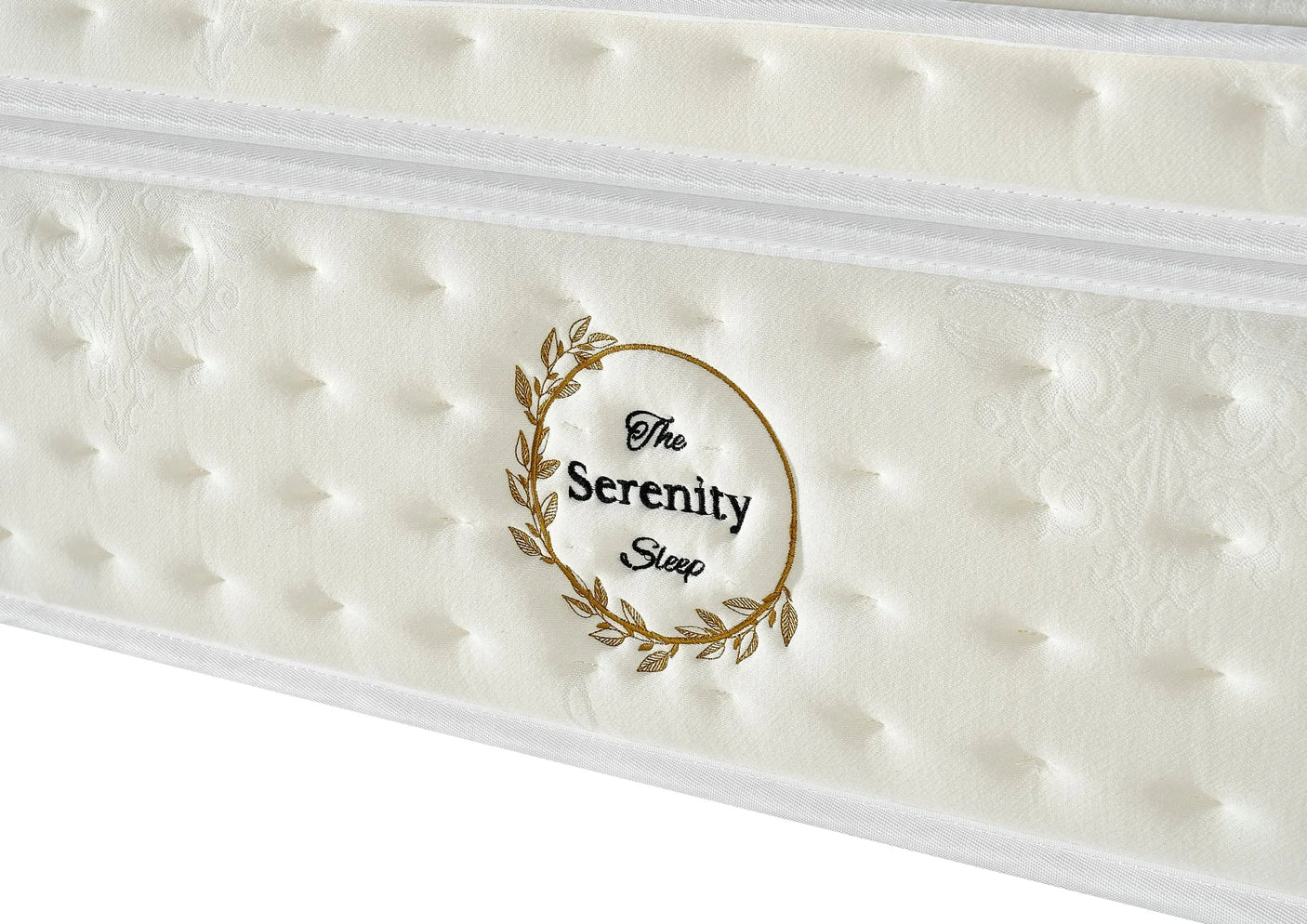 White Serenity Sleep mattress side panel with tufted detailing and gold embroidered logo