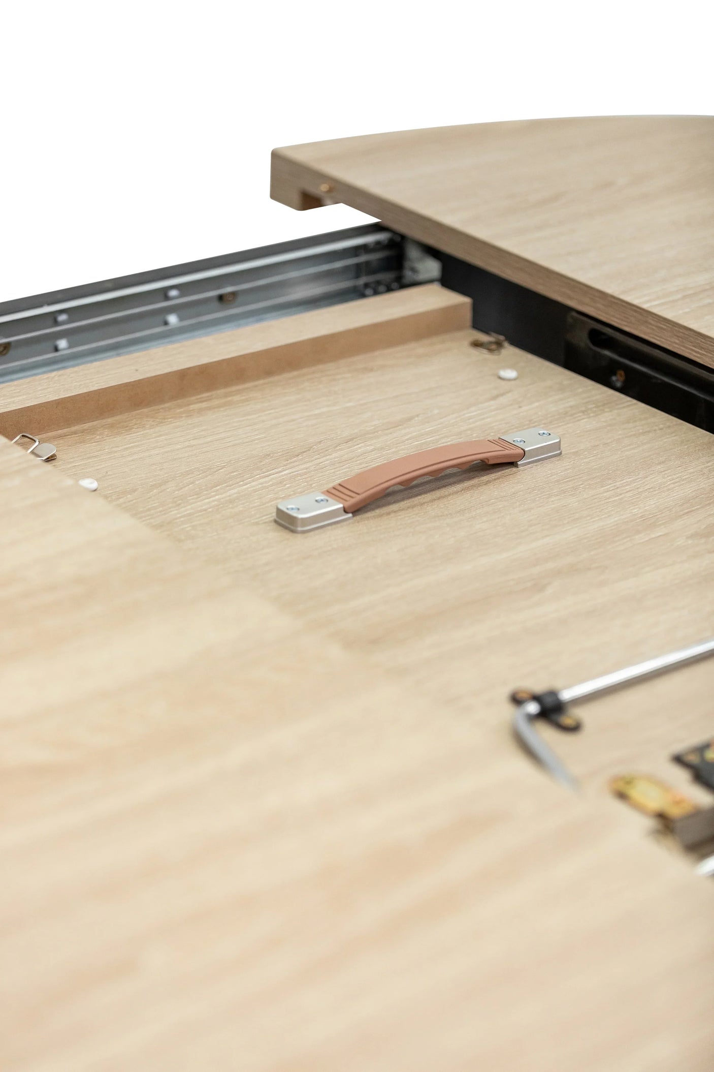 Close view of oak extendable dining table mechanism with handle and metal rail