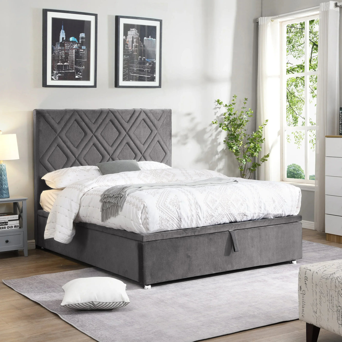 Grey upholstered ottoman bed with diamond panel headboard in bright bedroom