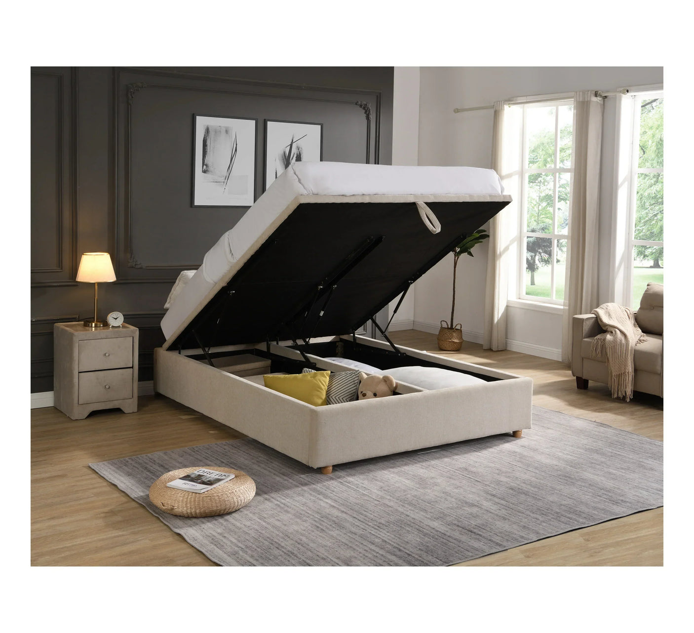 Beige ottoman storage bed with raised mattress in modern bedroom with nightstand and window