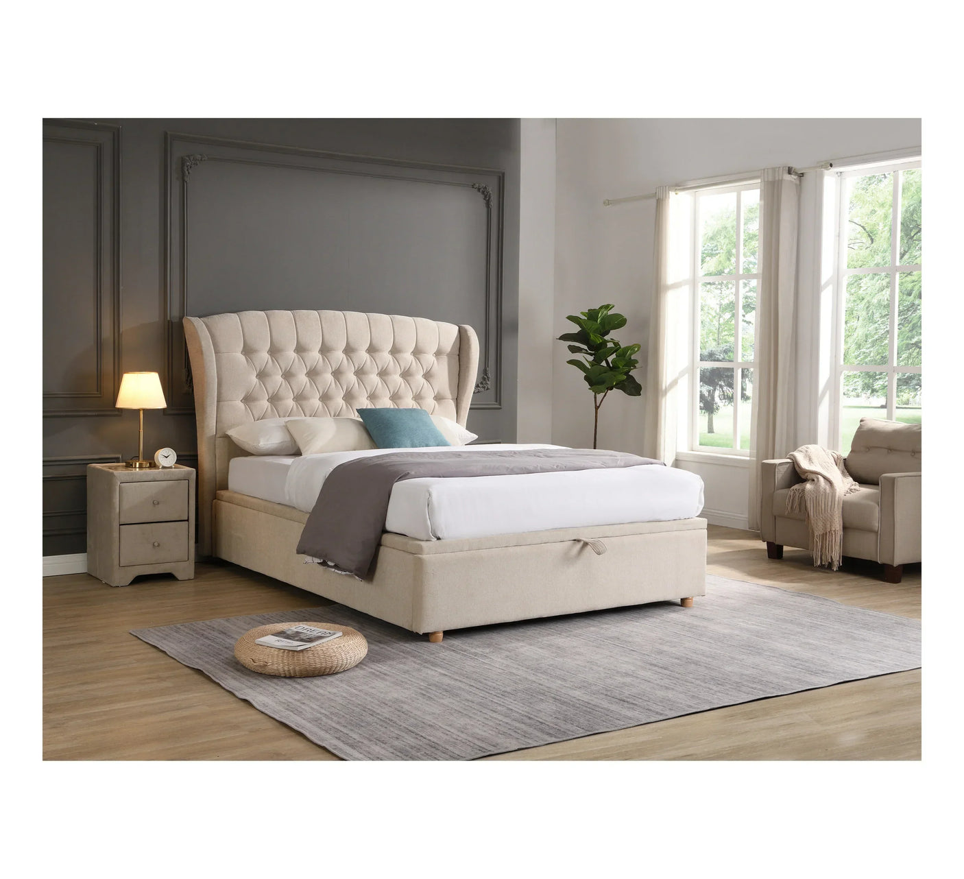 Beige upholstered bed with tufted headboard, matching bedside table and armchair in bedroom