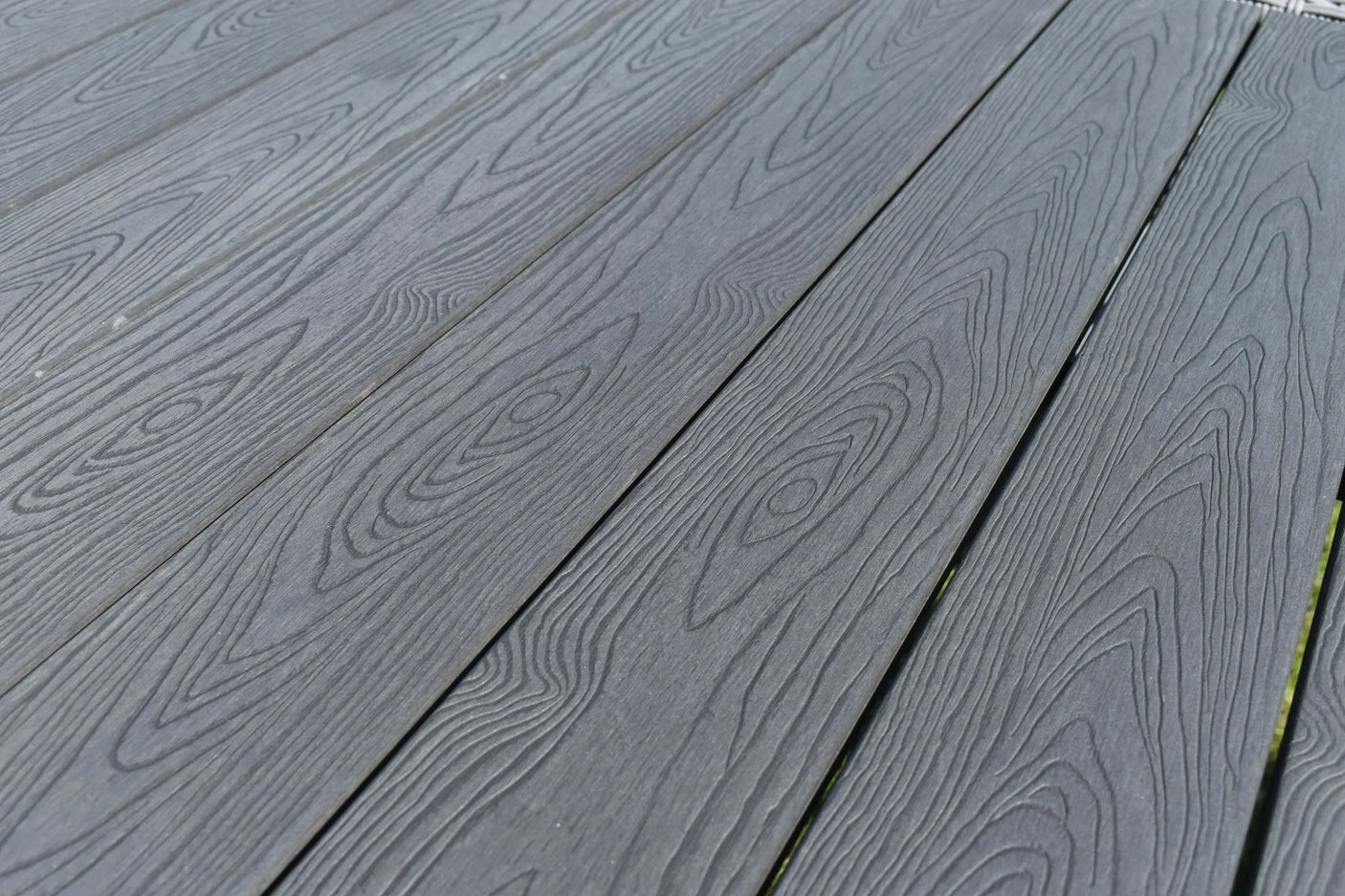 Grey composite decking boards with wood grain texture