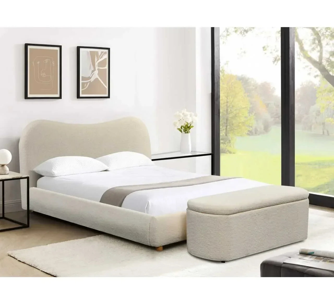 Cream upholstered bed with matching ottoman in modern bedroom with large window