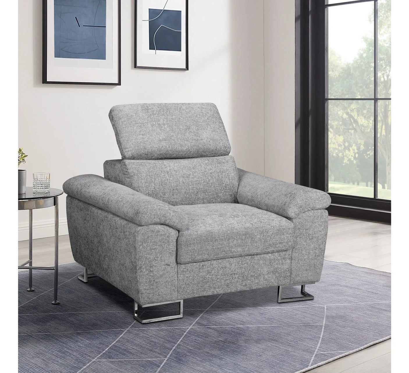 Grey fabric armchair with chrome legs in living room by large window