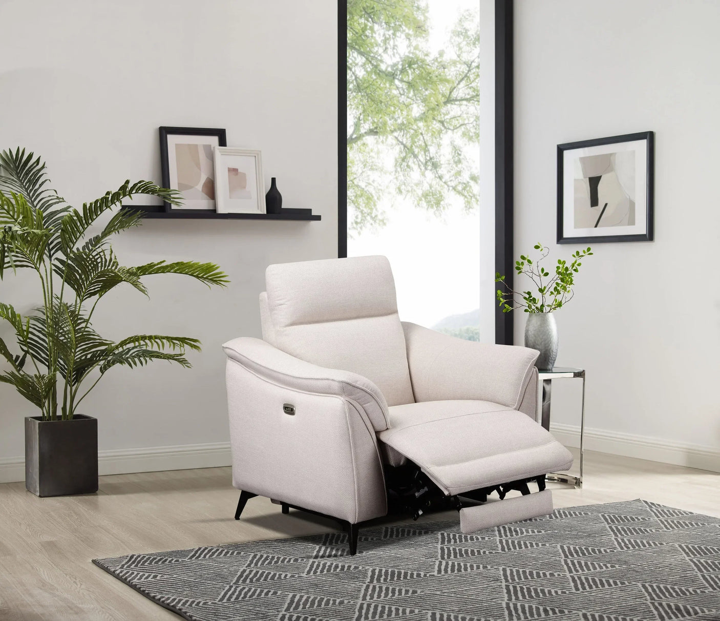Cream fabric recliner armchair in modern living room with geometric rug and indoor plants