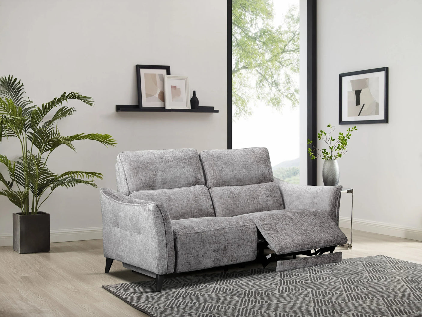 Grey fabric reclining sofa with chaise footrest in modern living room setting