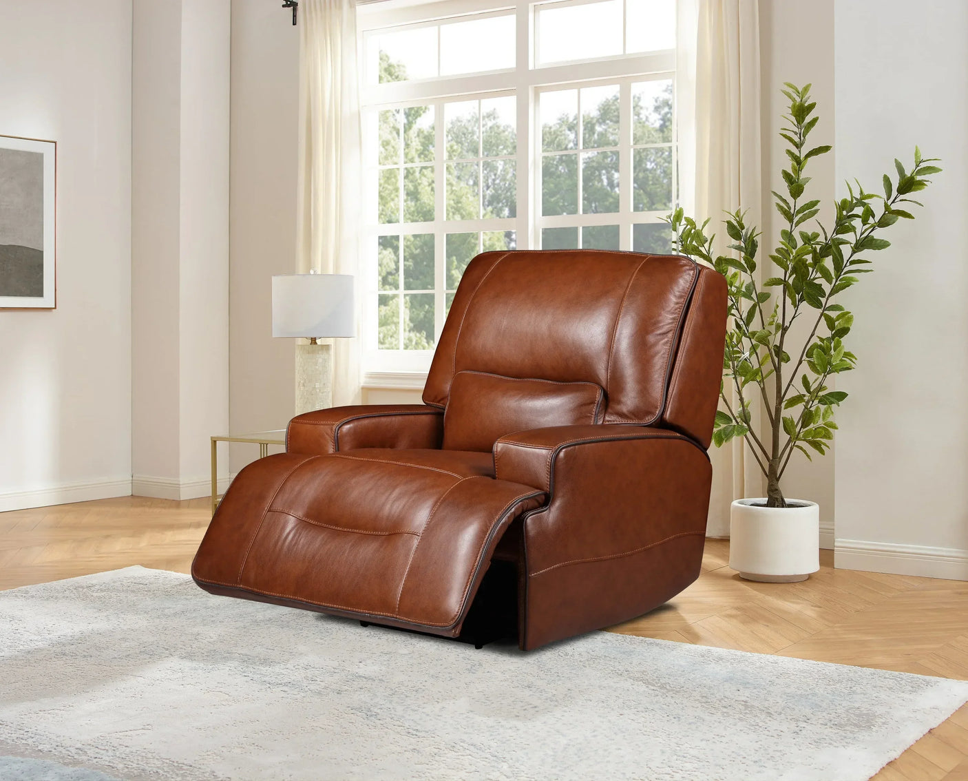 Brown leather recliner chair in living room with large window, potted plant, and area rug