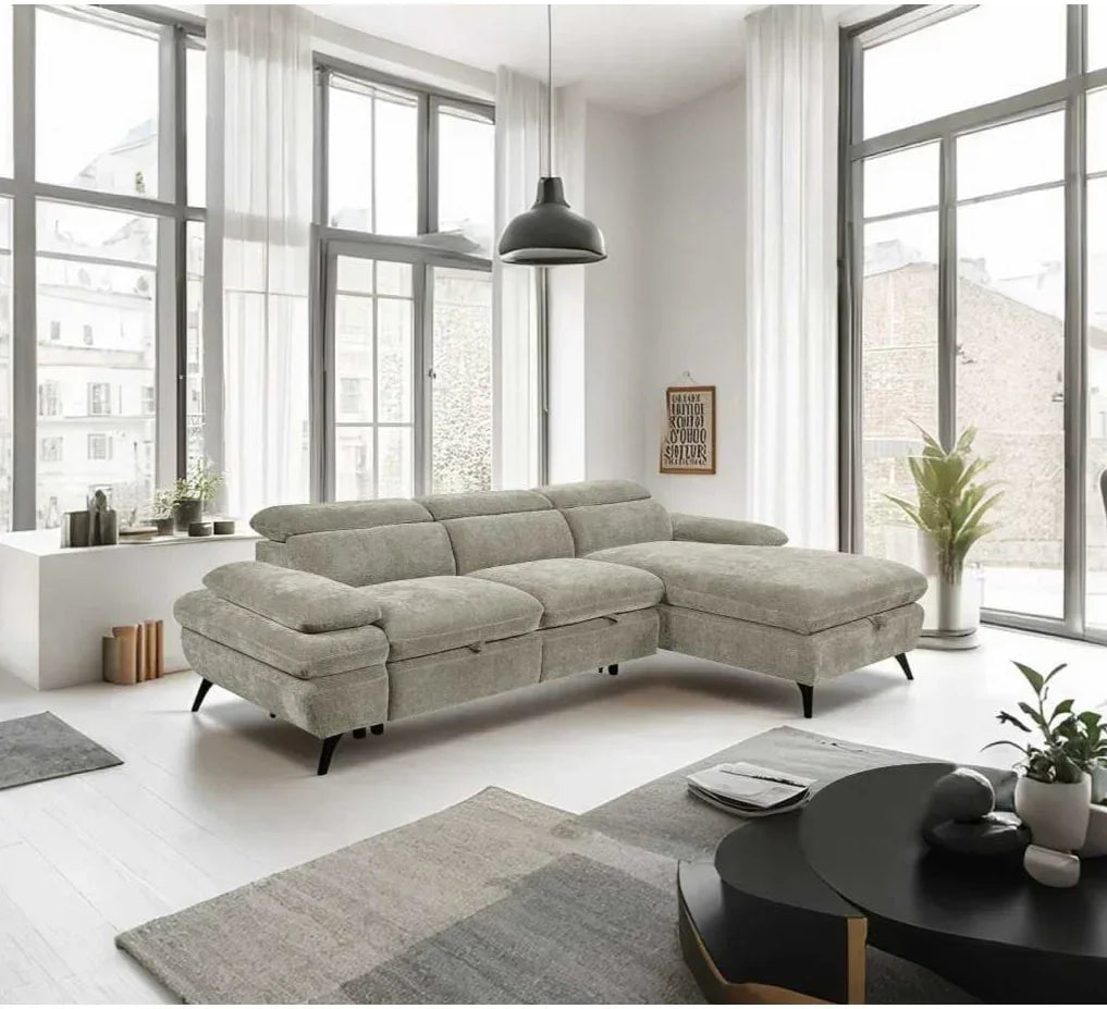 Light grey corner sofa with chaise in modern living room with large windows and black coffee table