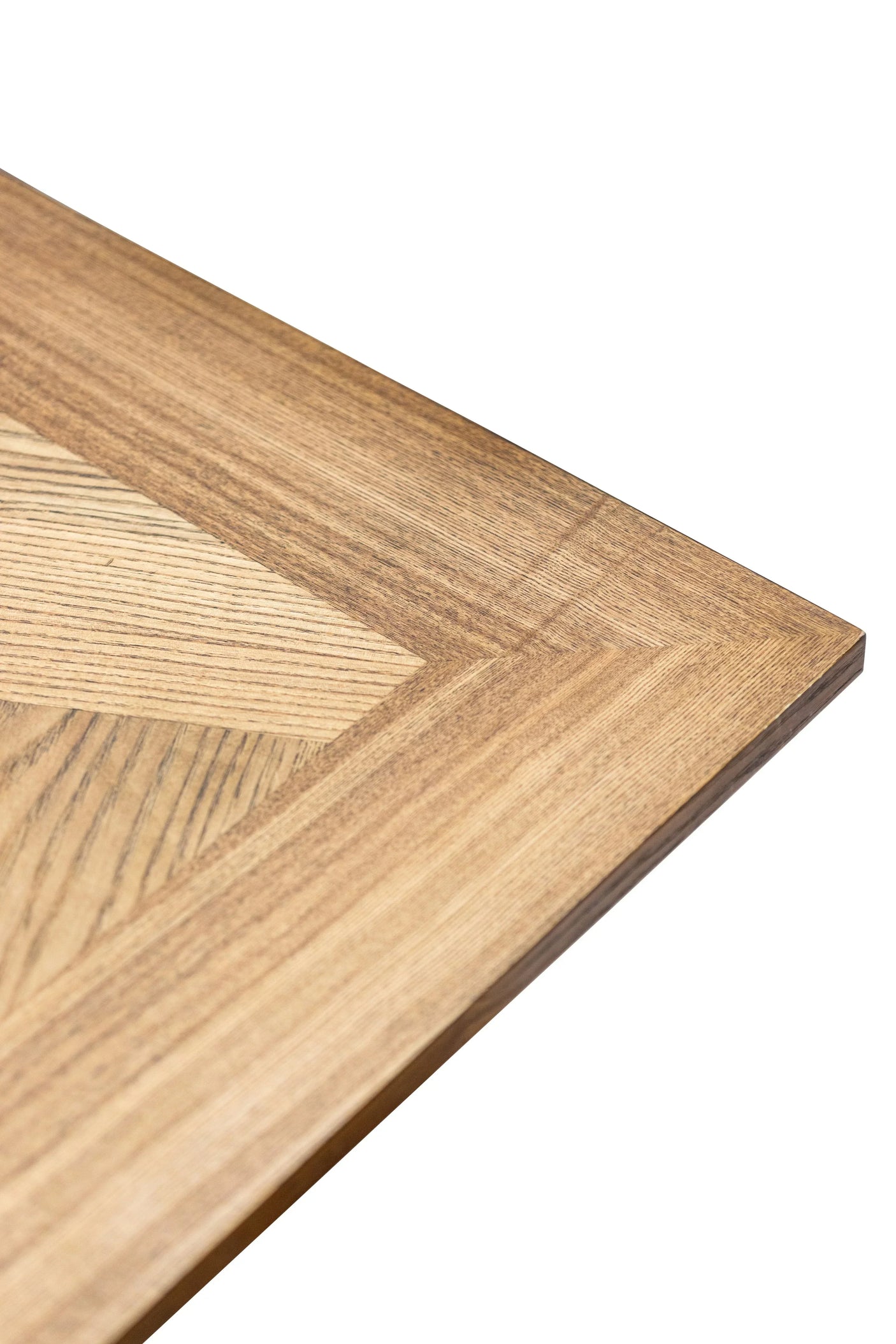 Light oak wood dining table corner with chevron grain detail
