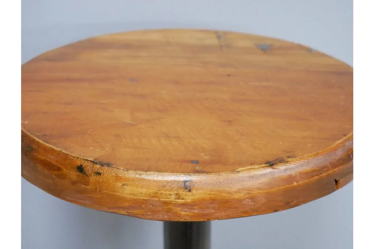Round wooden table top with natural grain and visible rustic finish