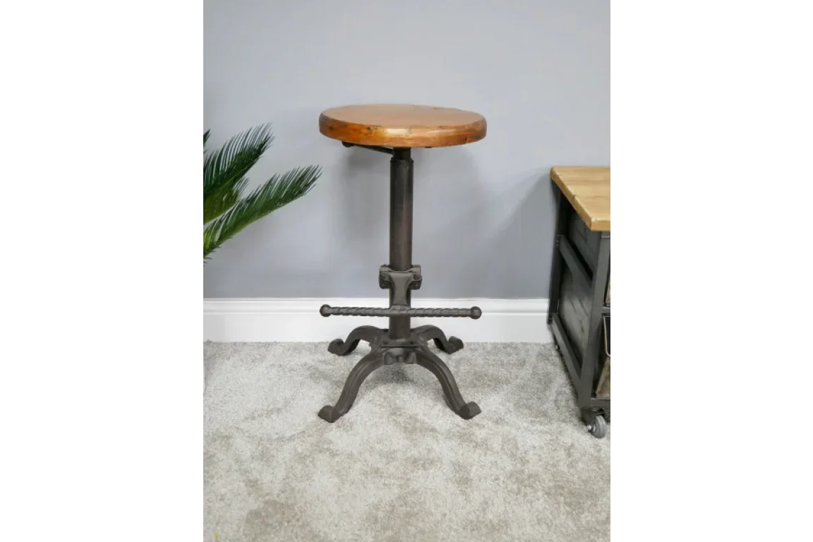 Industrial bar stool with round wooden seat and black metal base in modern room