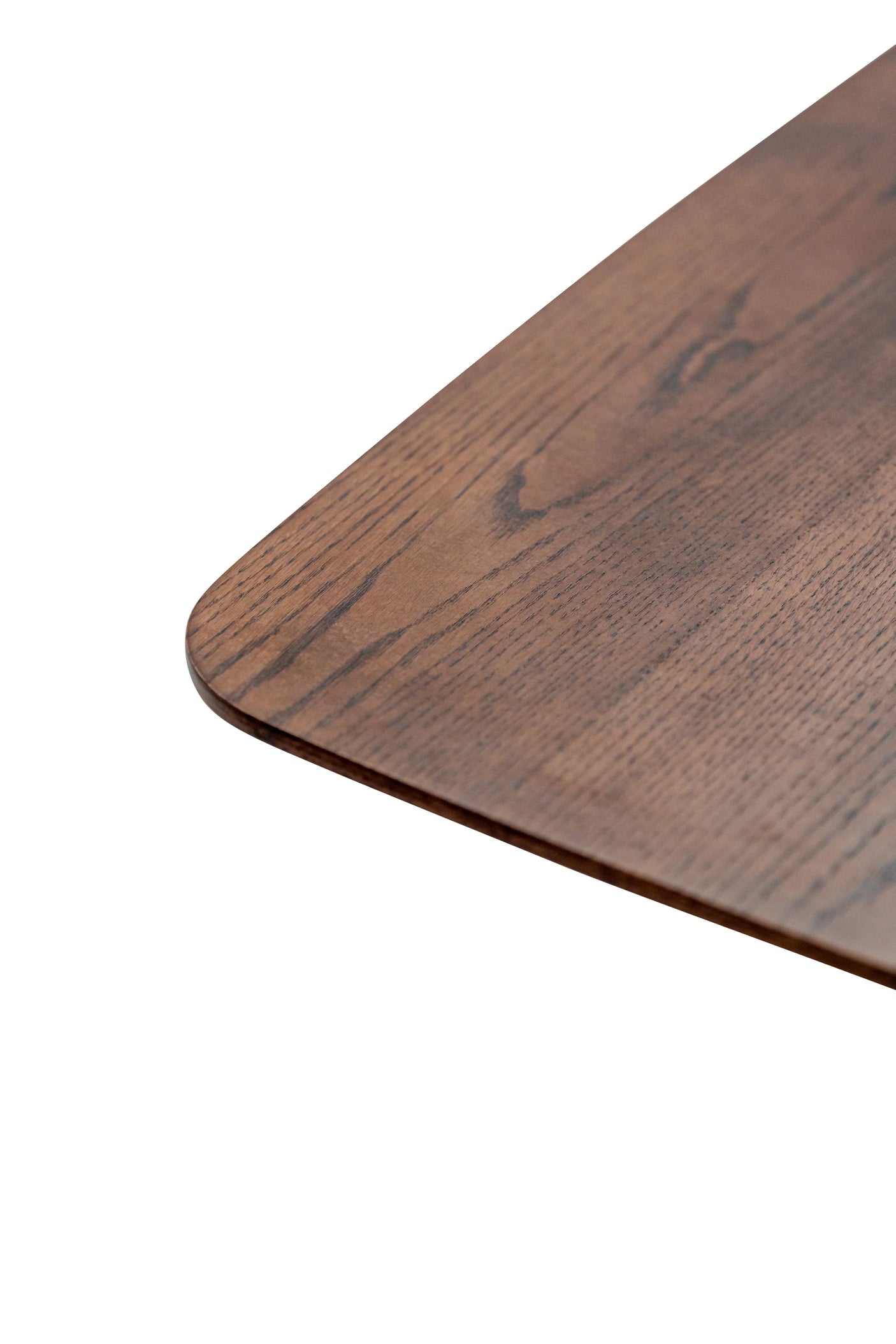 Closeup of dark wood dining table top with rounded corner and natural grain detail