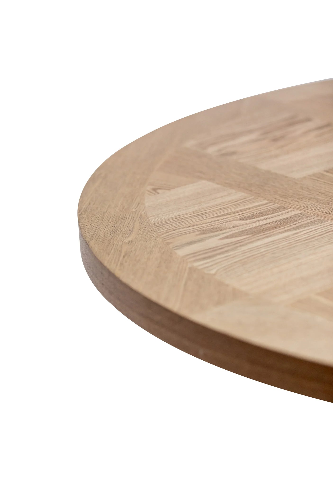 Round wood dining table with natural grain detail, close-up of tabletop edge