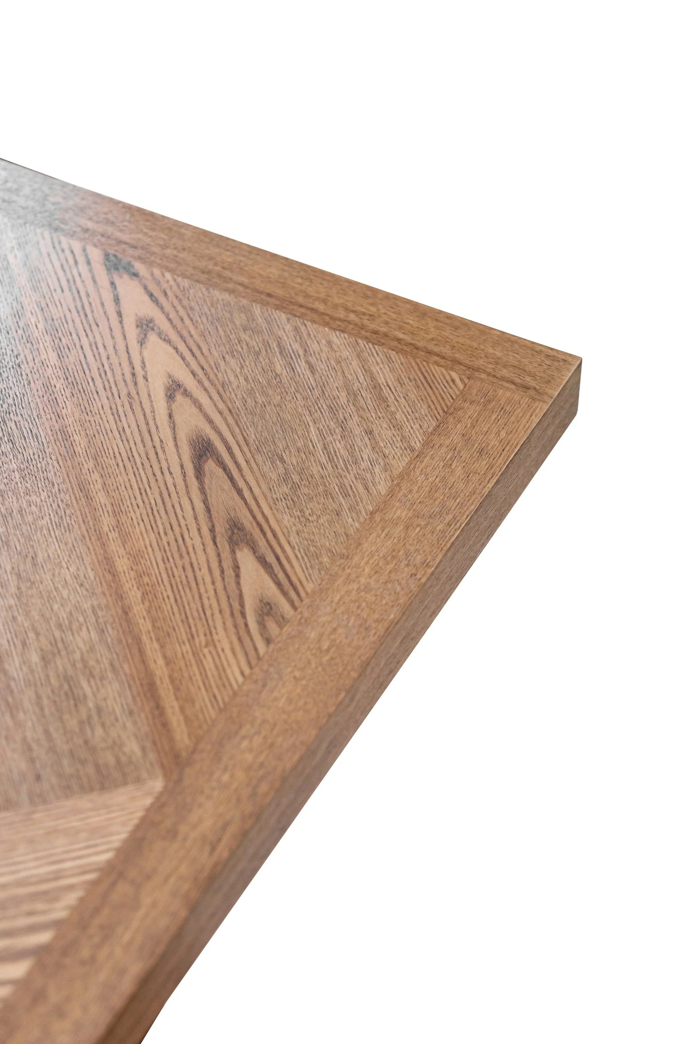 Close-up of wooden dining table top with natural grain detail and mitered edge