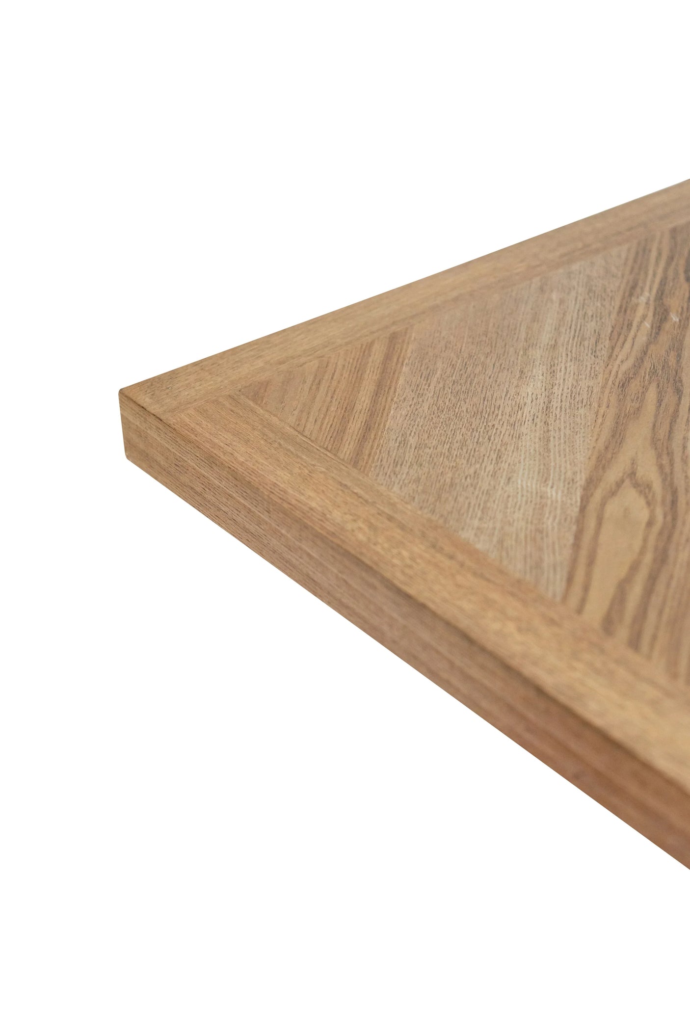 Closeup of oak dining table corner with natural wood grain and beveled edge