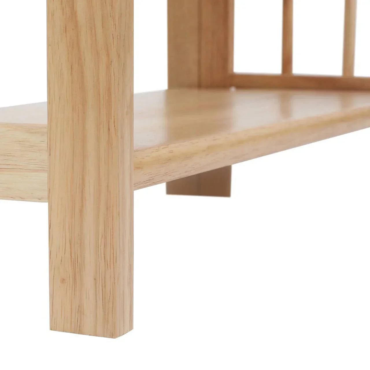 Natural wood furniture leg and lower shelf closeup