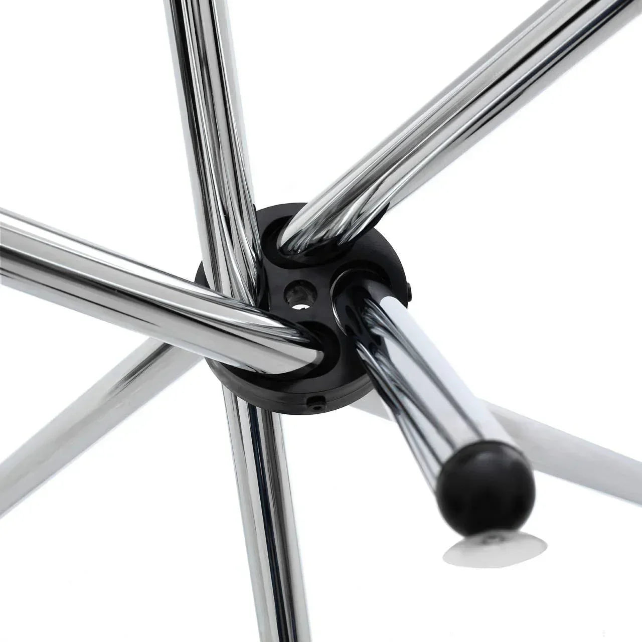 Closeup of chrome dining chair legs with black plastic floor protector detail
