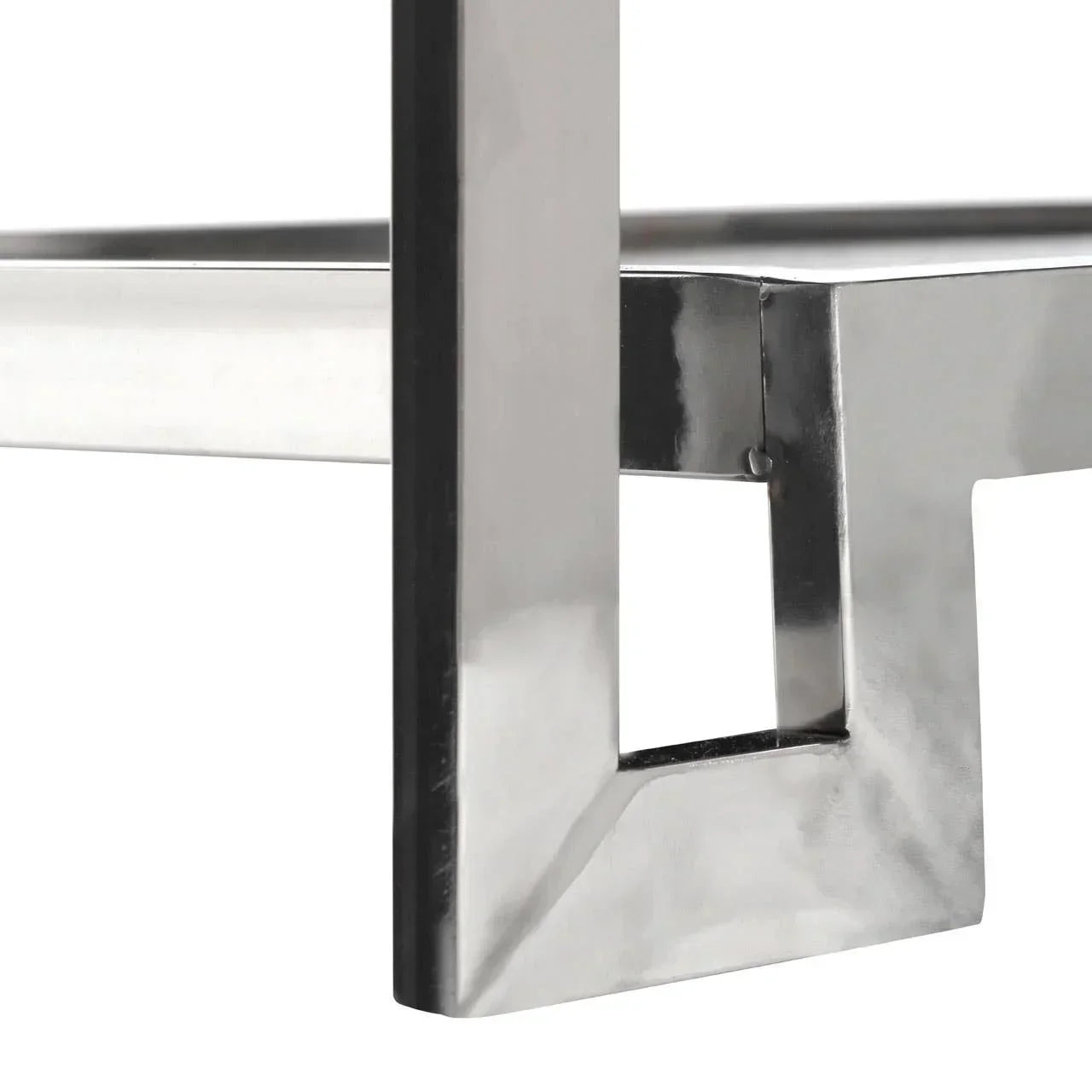 Close up of stainless steel table leg with polished metallic frame and angular design