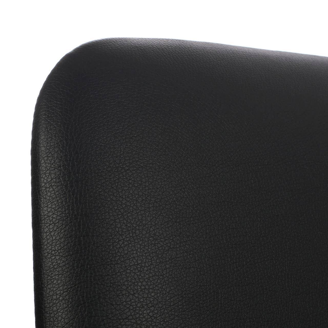 Close-up of black faux leather chair backrest with textured surface
