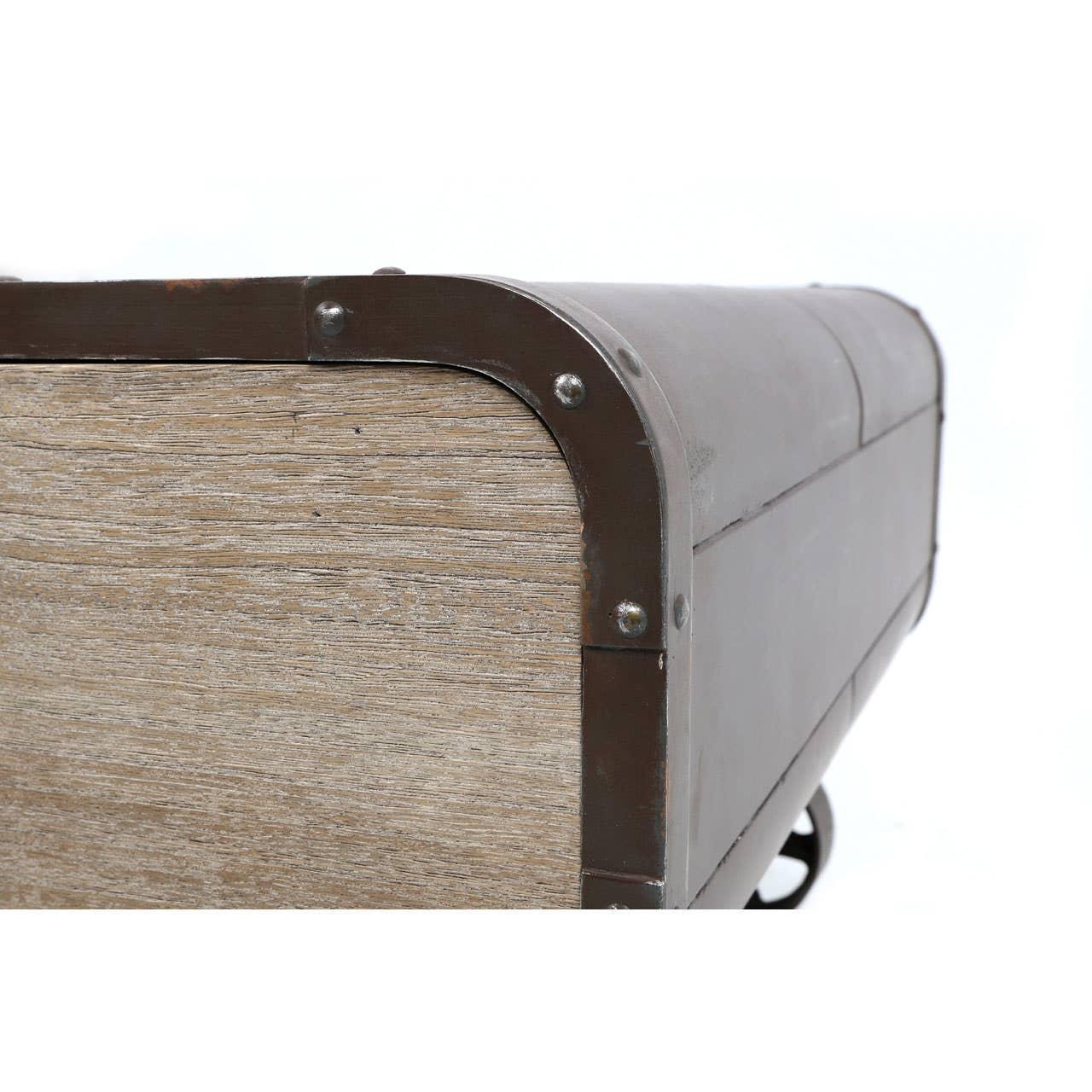 Closeup of wooden storage trunk with metal trim and rivet detail on corner