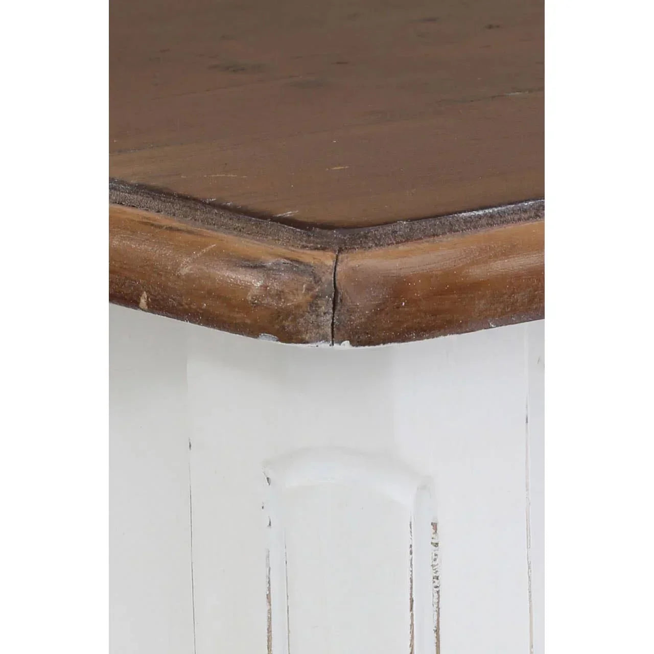 Rustic wooden table corner with dark brown top and distressed white painted base