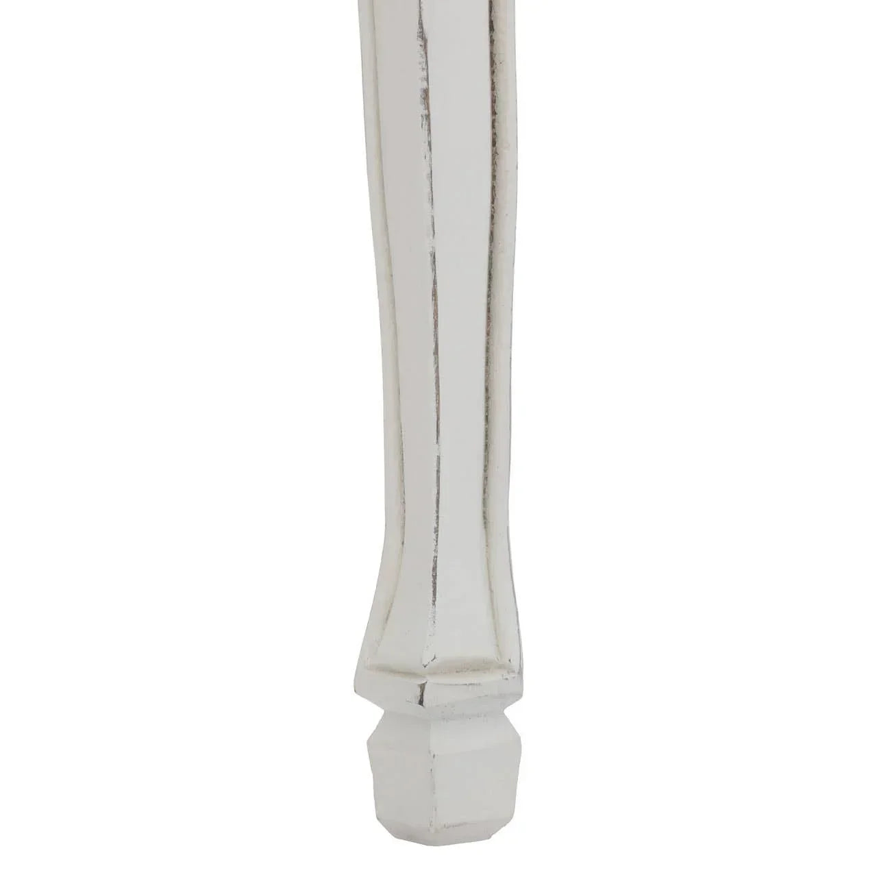 Distressed white wooden furniture leg with carved detailing close up