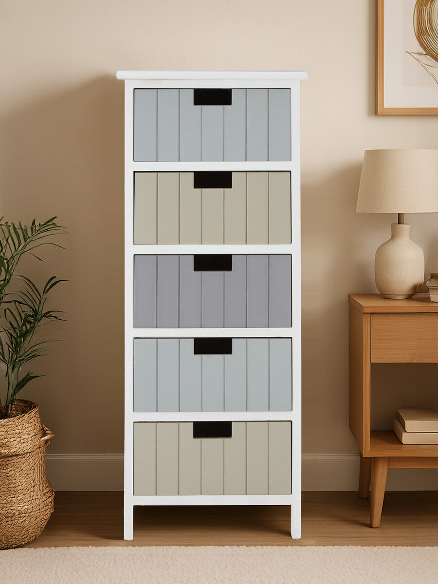 A tall, white chest of drawers featuring five woven fabric drawers in light gray and beige, with black handles. The chest is positioned against a neutral wall, accompanied by a decorative lamp and a small potted plant on a wooden side table nearby