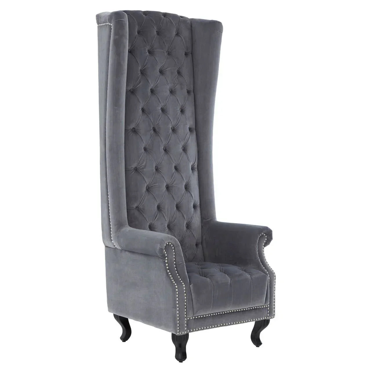 Grey velvet high back armchair with button tufting and silver stud trim on black legs