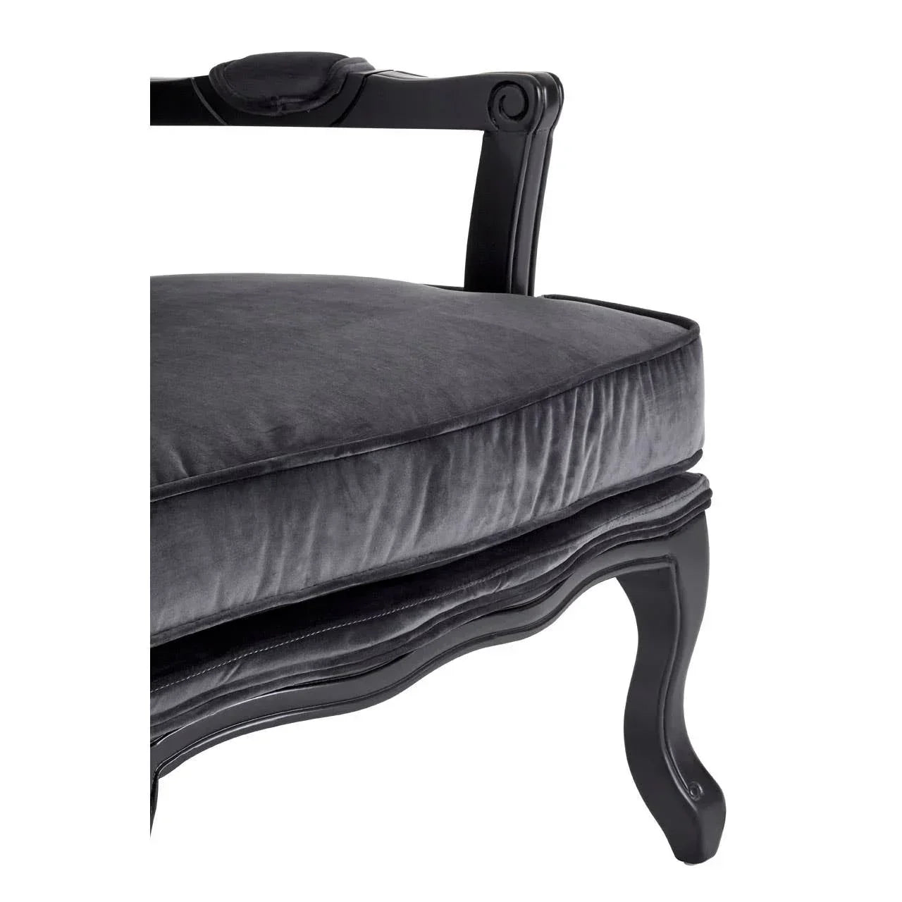 Black velvet dining chair with carved wooden leg and curved seat detail