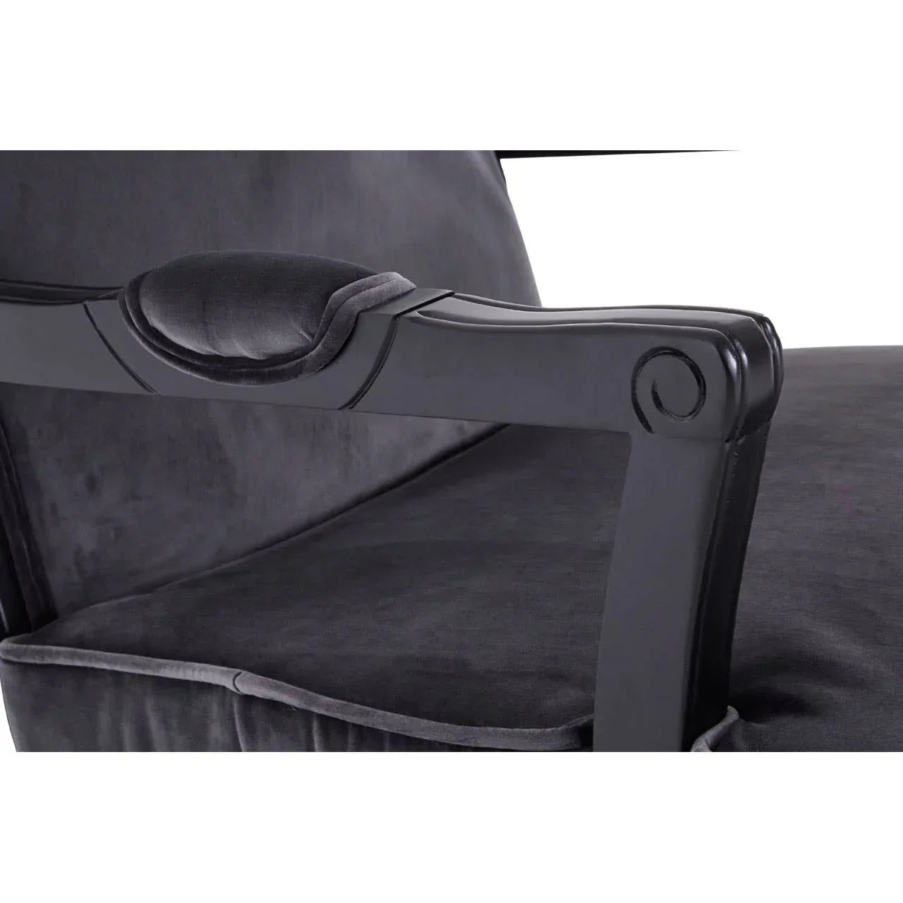 Close up of black velvet armchair with padded armrest and wooden frame detail