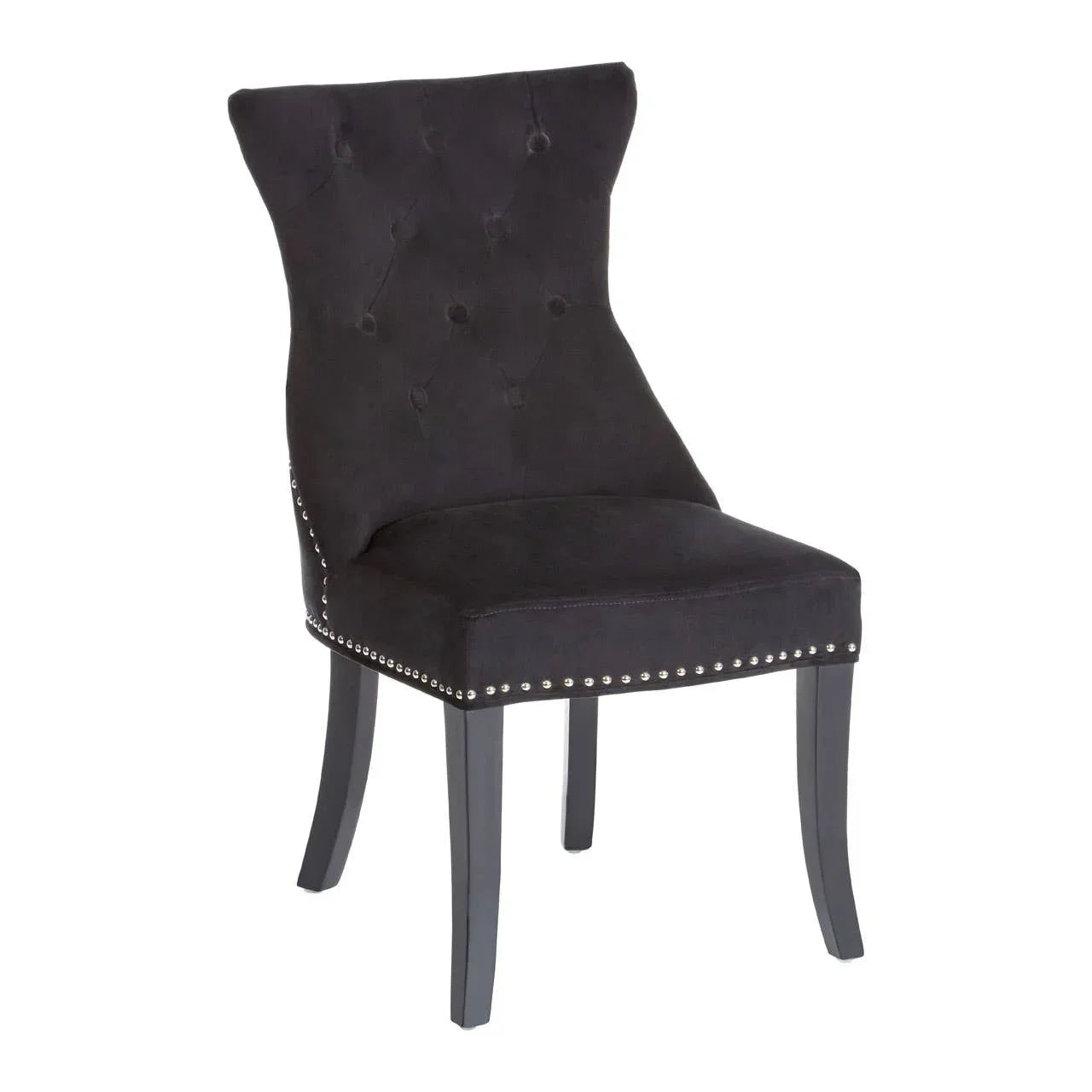 Black velvet dining chair with tufted backrest and silver stud detailing on seat edge