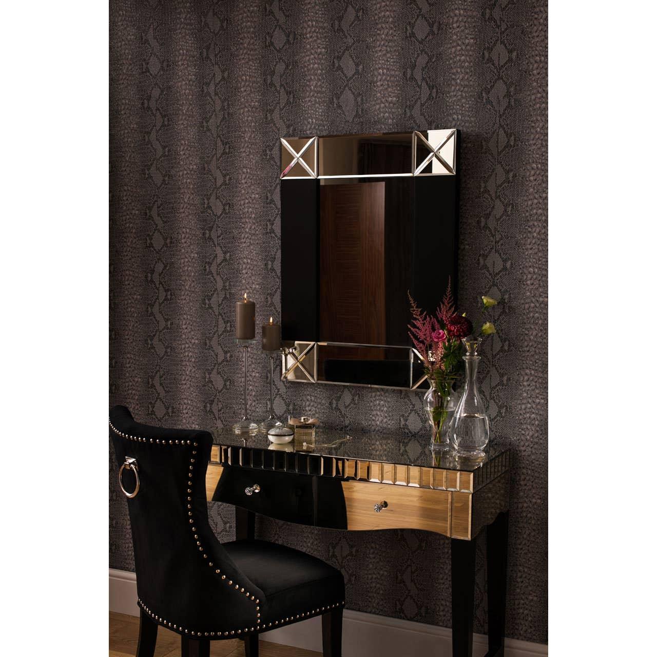 Glass dressing table with gold accents, black velvet chair, and wall mirror in modern room