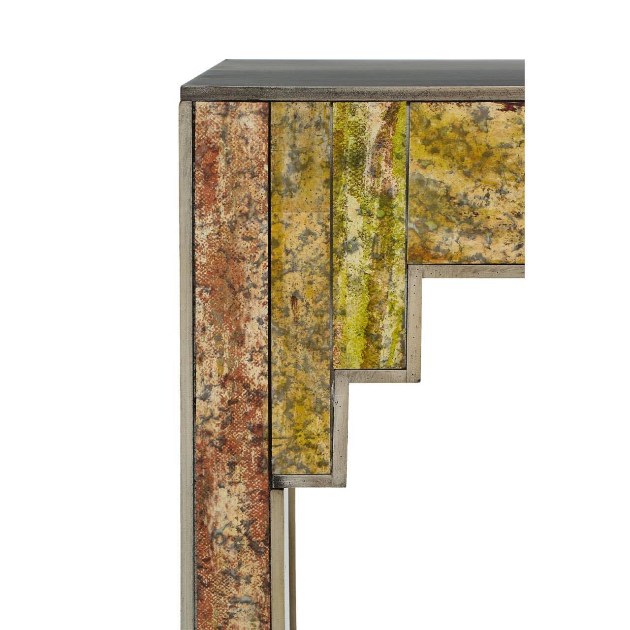Closeup of console table with multicolored distressed metal panels and stepped edge design