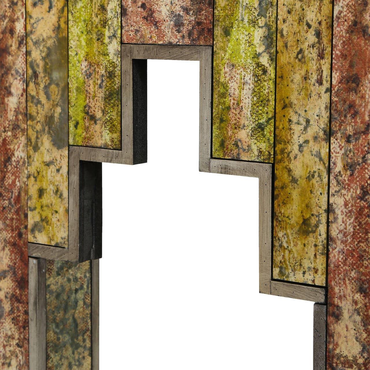 Closeup of textured multicolor console table legs with angular cut-out design