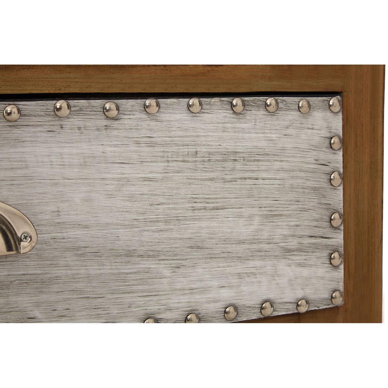 Close up of metal drawer front with brushed finish and studded detailing