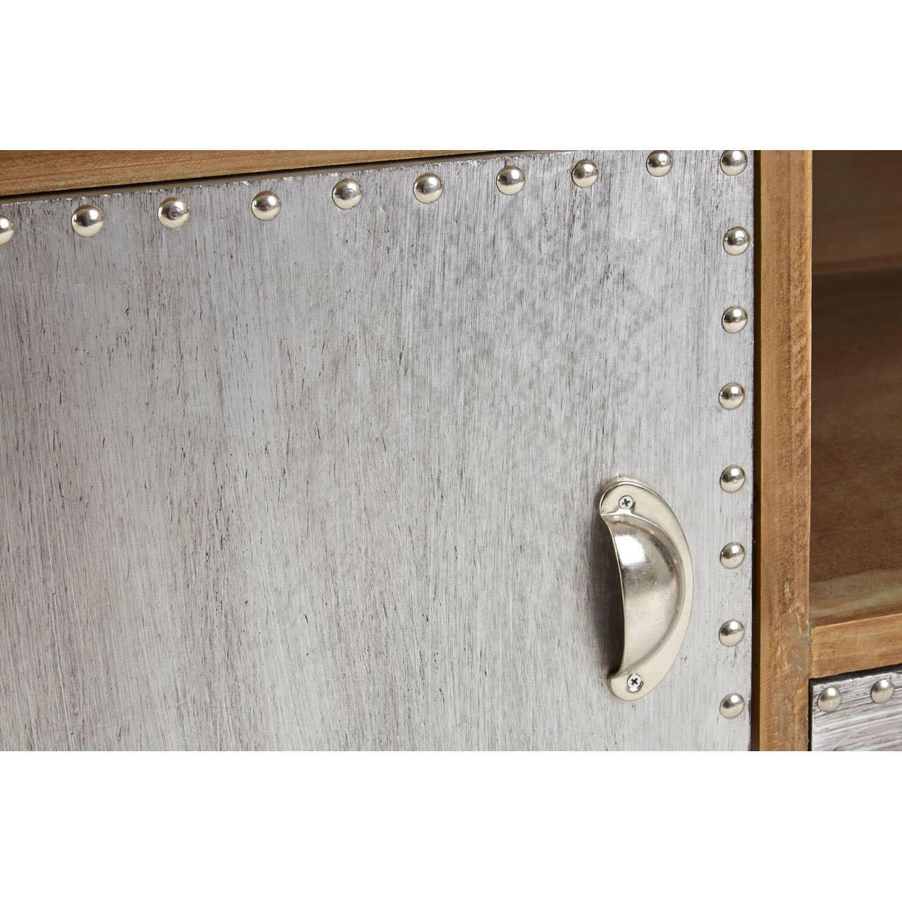 Closeup of metal cabinet door with rivet trim and silver handle, wood interior visible