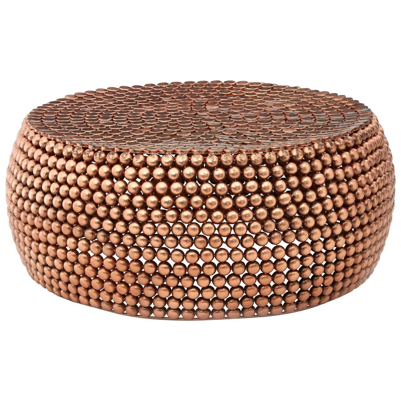Round copper coffee table with textured ball design and metallic finish
