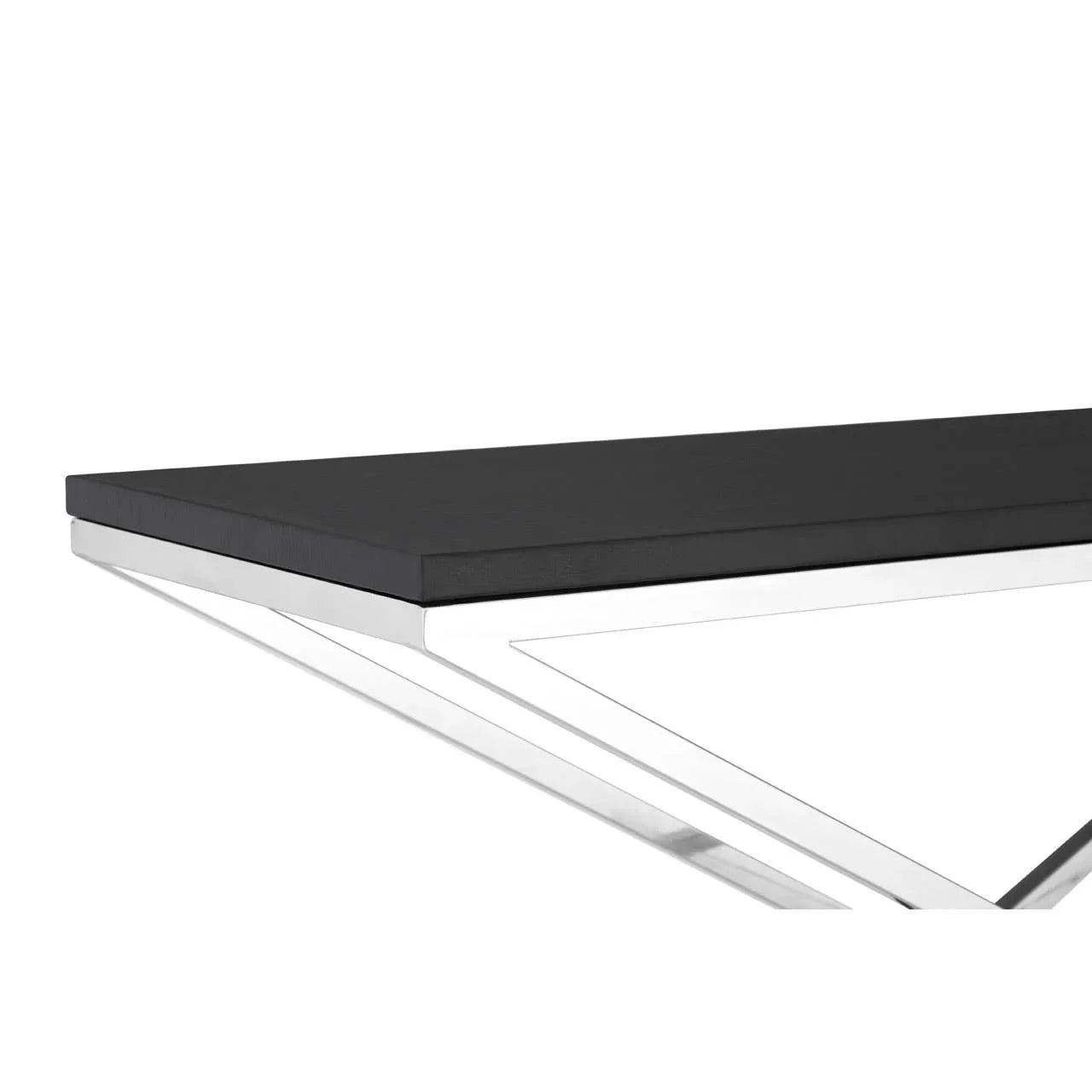 Black dining table with rectangular top and chrome metal frame, close-up corner view