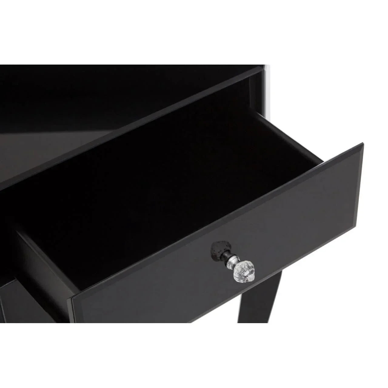 Black bedside table with open drawer and crystal handle, glossy finish, close-up view