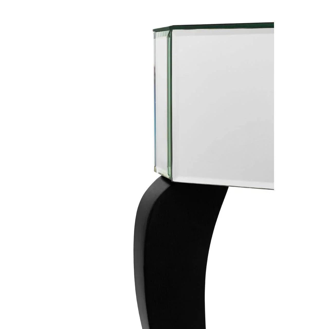 Close-up of mirrored console table corner with curved black leg detail