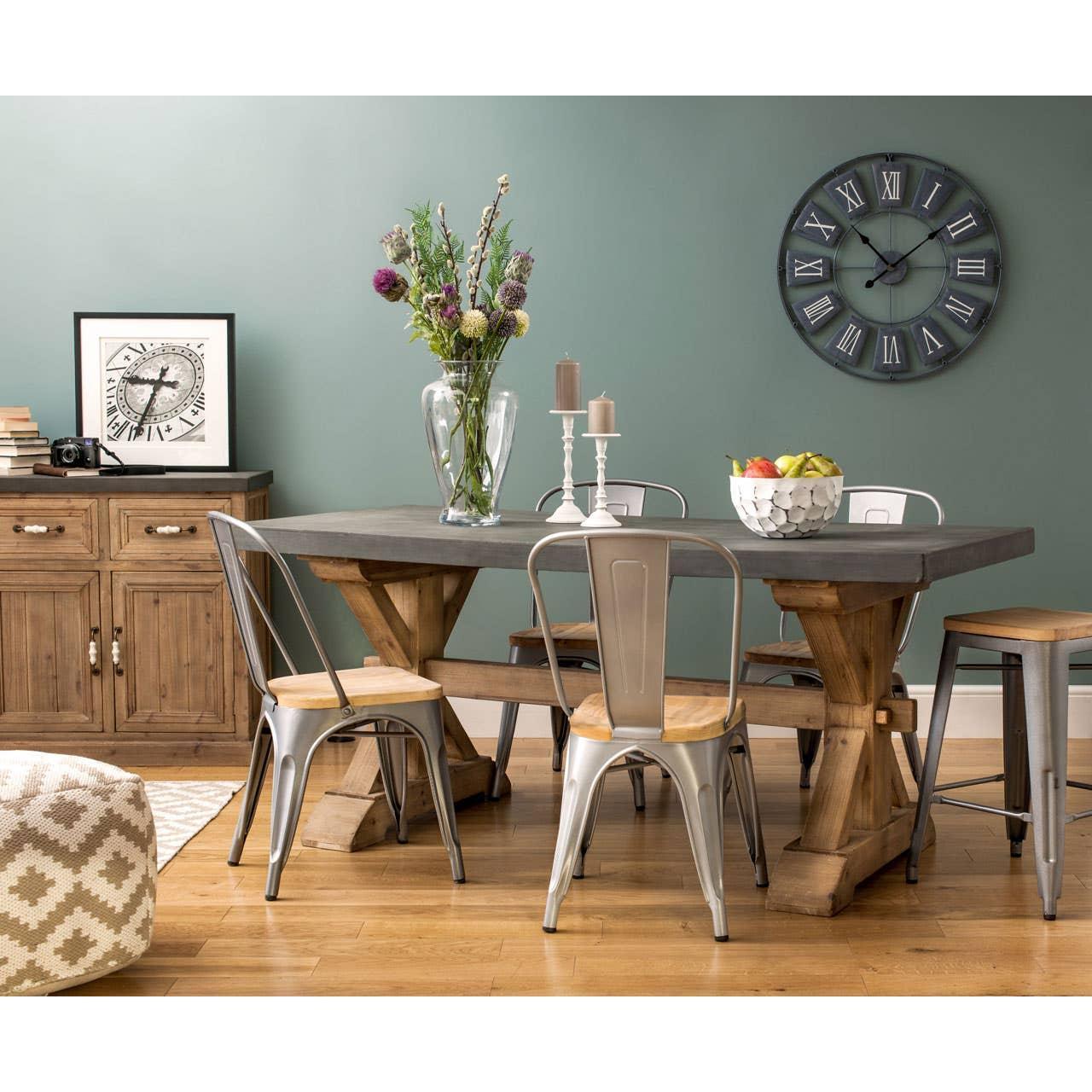 Rustic wooden dining table with metal chairs and vase in modern dining room setting