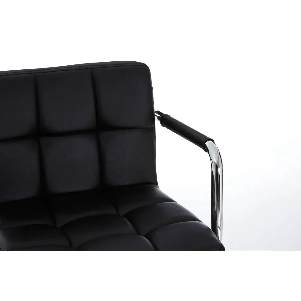 Black leather dining chair with padded seat and chrome metal armrest close-up