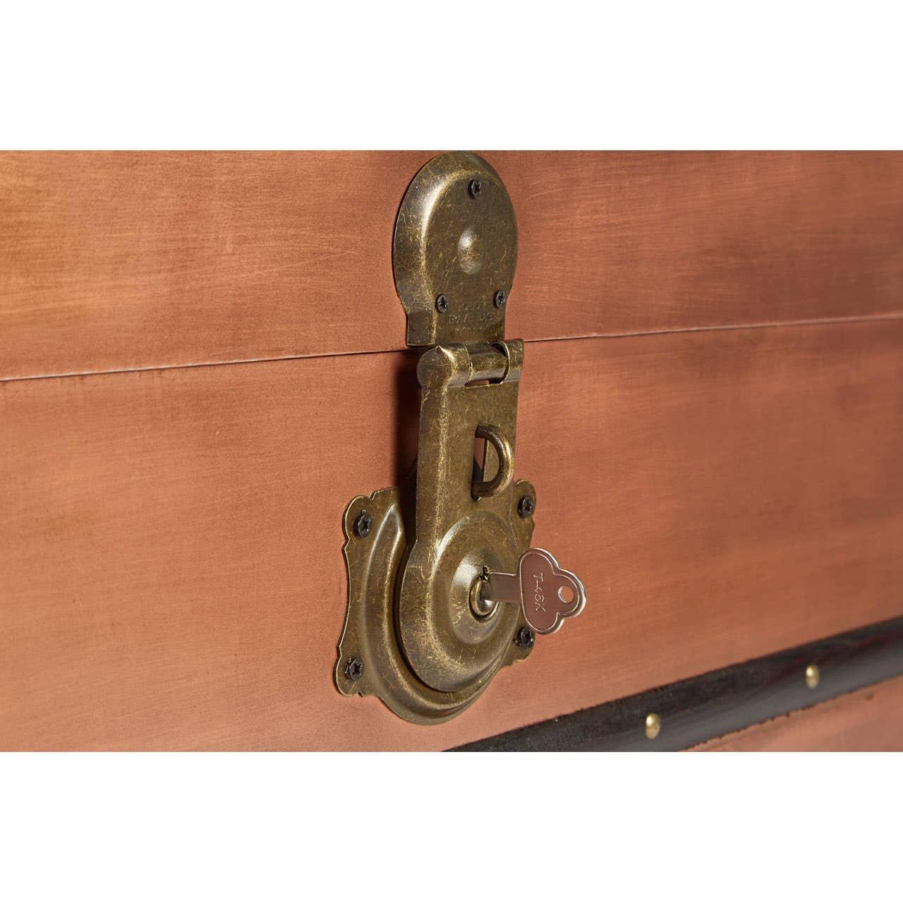 Close-up of trunk lock and key on wooden storage chest
