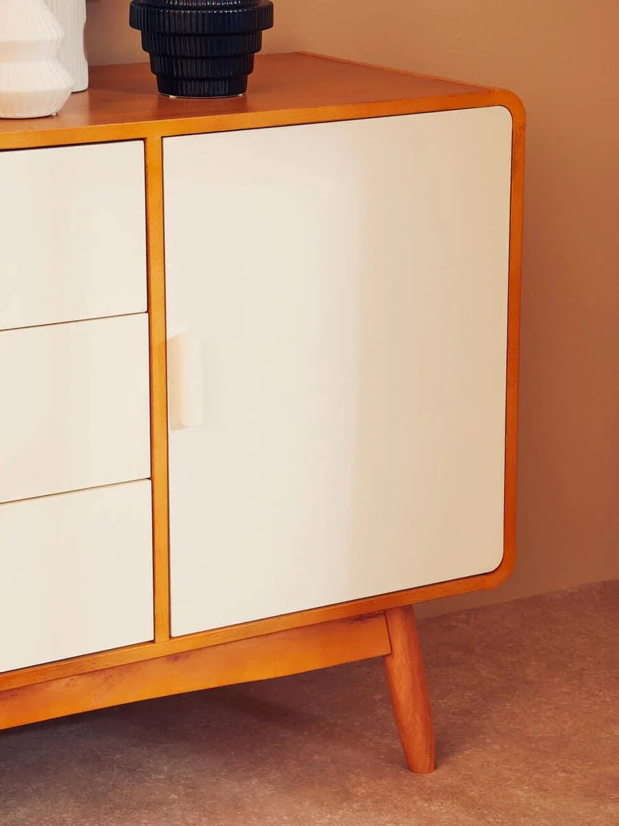 modern wood sideboard with cream doors and angled legs, ceramic vases on top