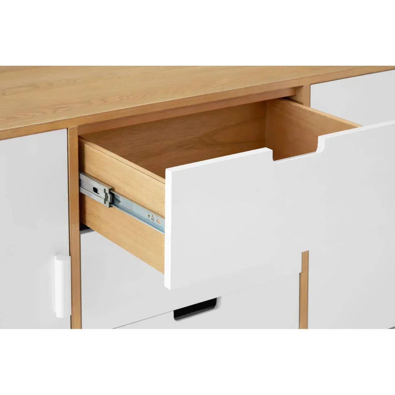 White sideboard cabinet with open wooden drawer and smooth metal glide rails