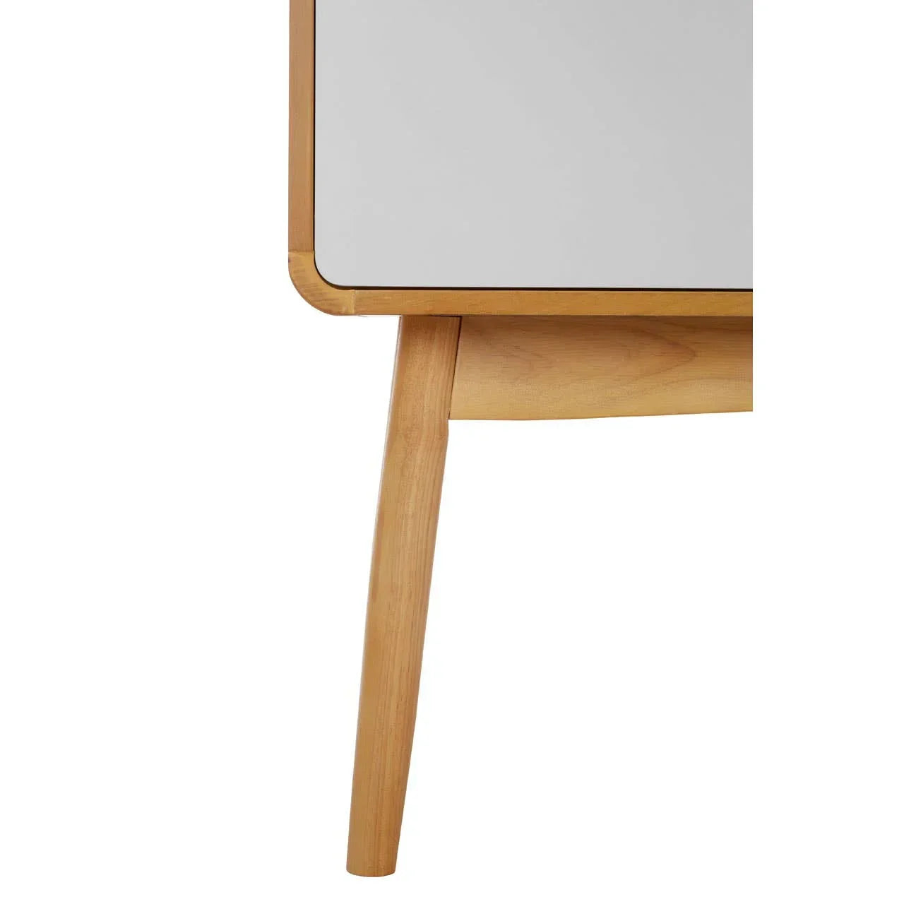 Close-up of light wood furniture leg with angled support and smooth white panel