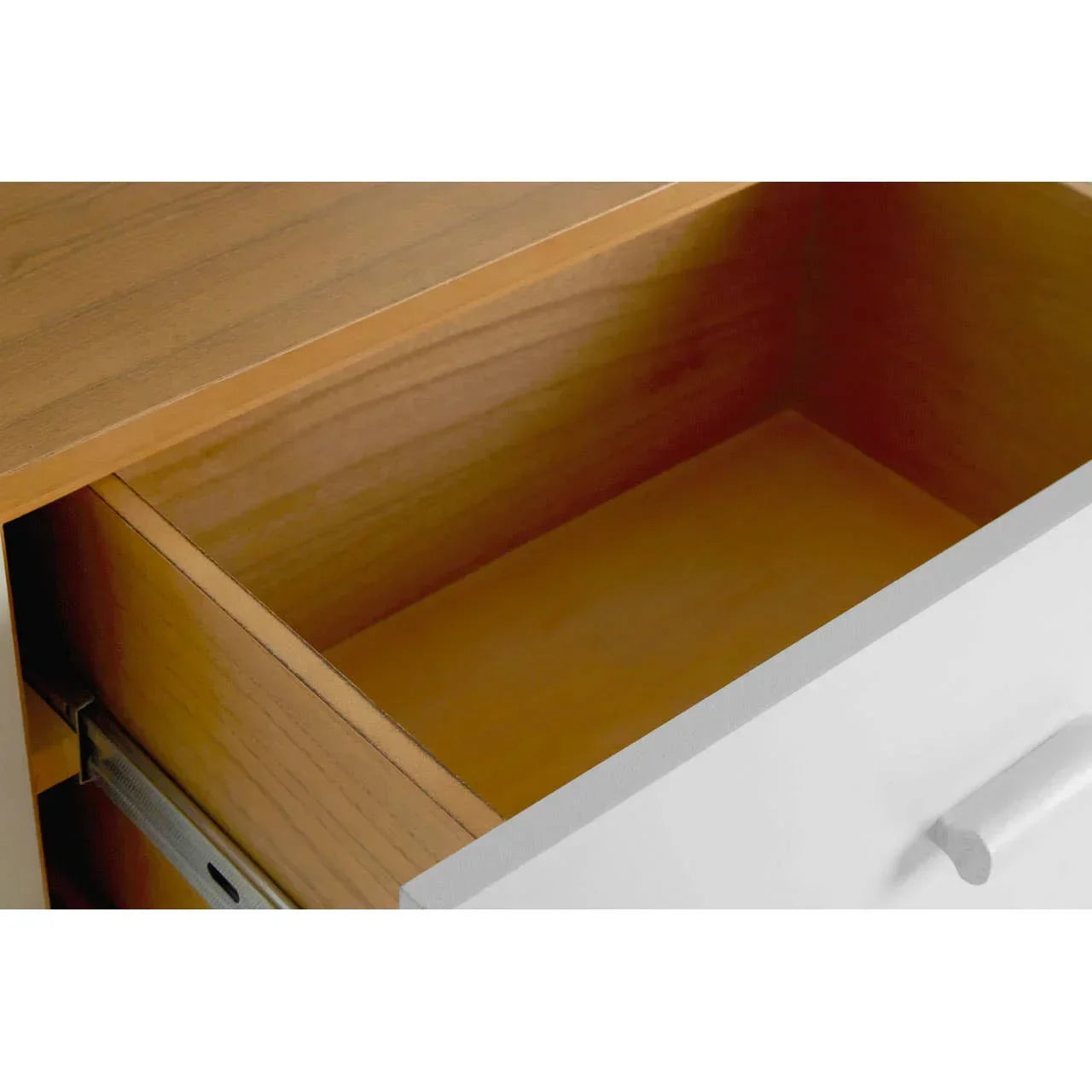 Open wooden drawer with white front and metal runner, close-up of interior storage space