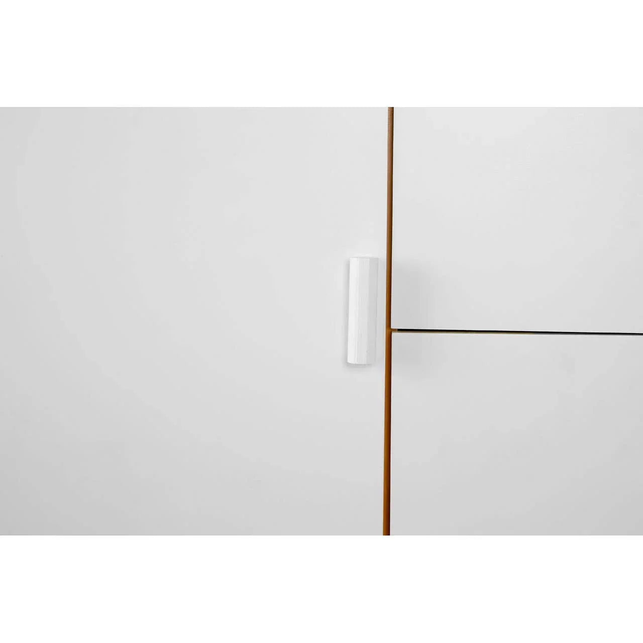White cabinet door with vertical handle and wooden trim detail