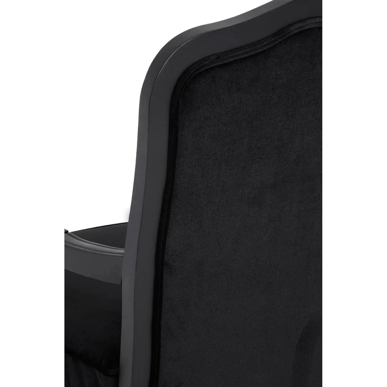 Black velvet dining chair backrest with curved wooden frame closeup